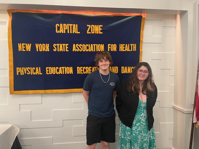 Two seniors stand for their awards