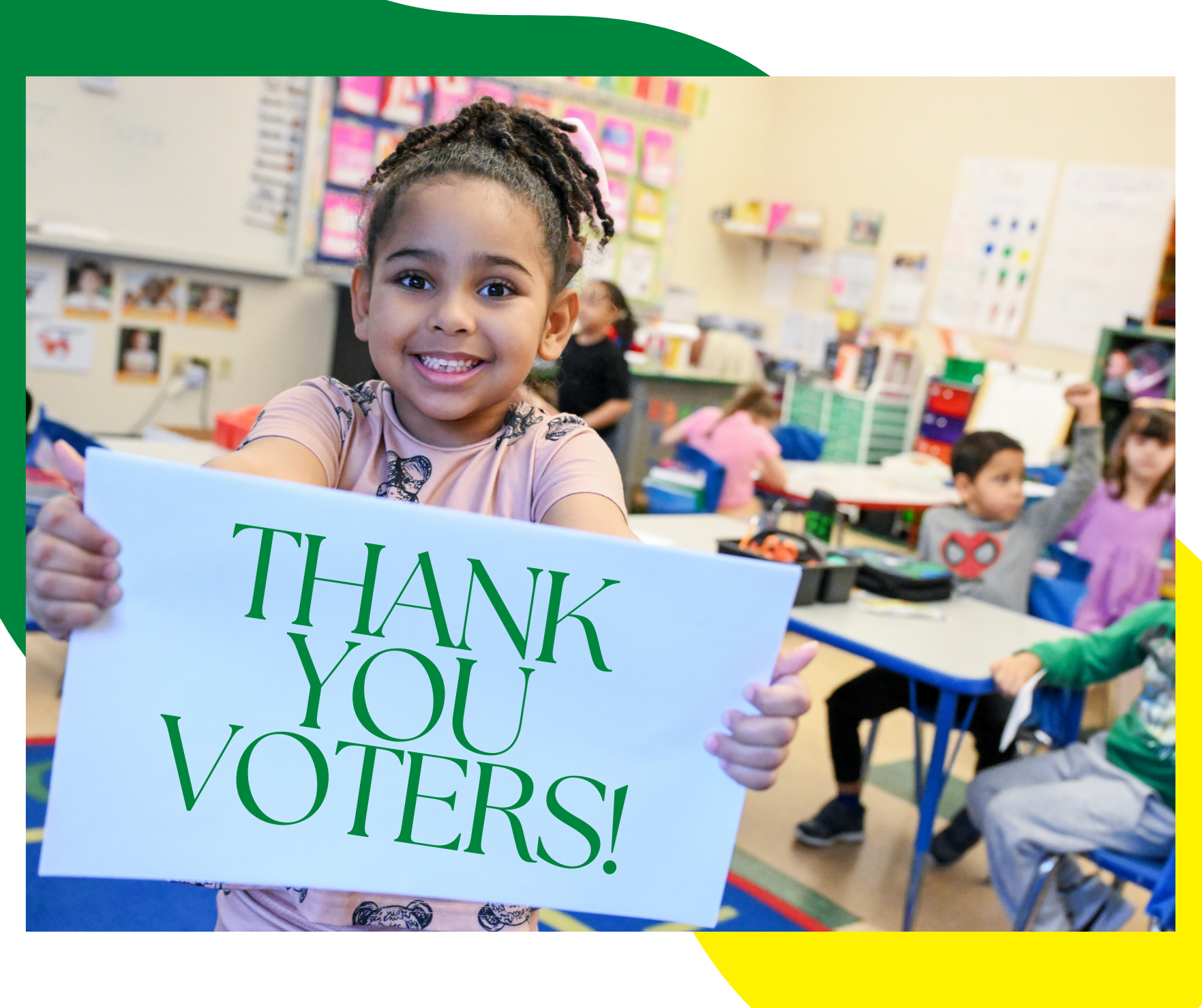 Child holds sign thanking voters